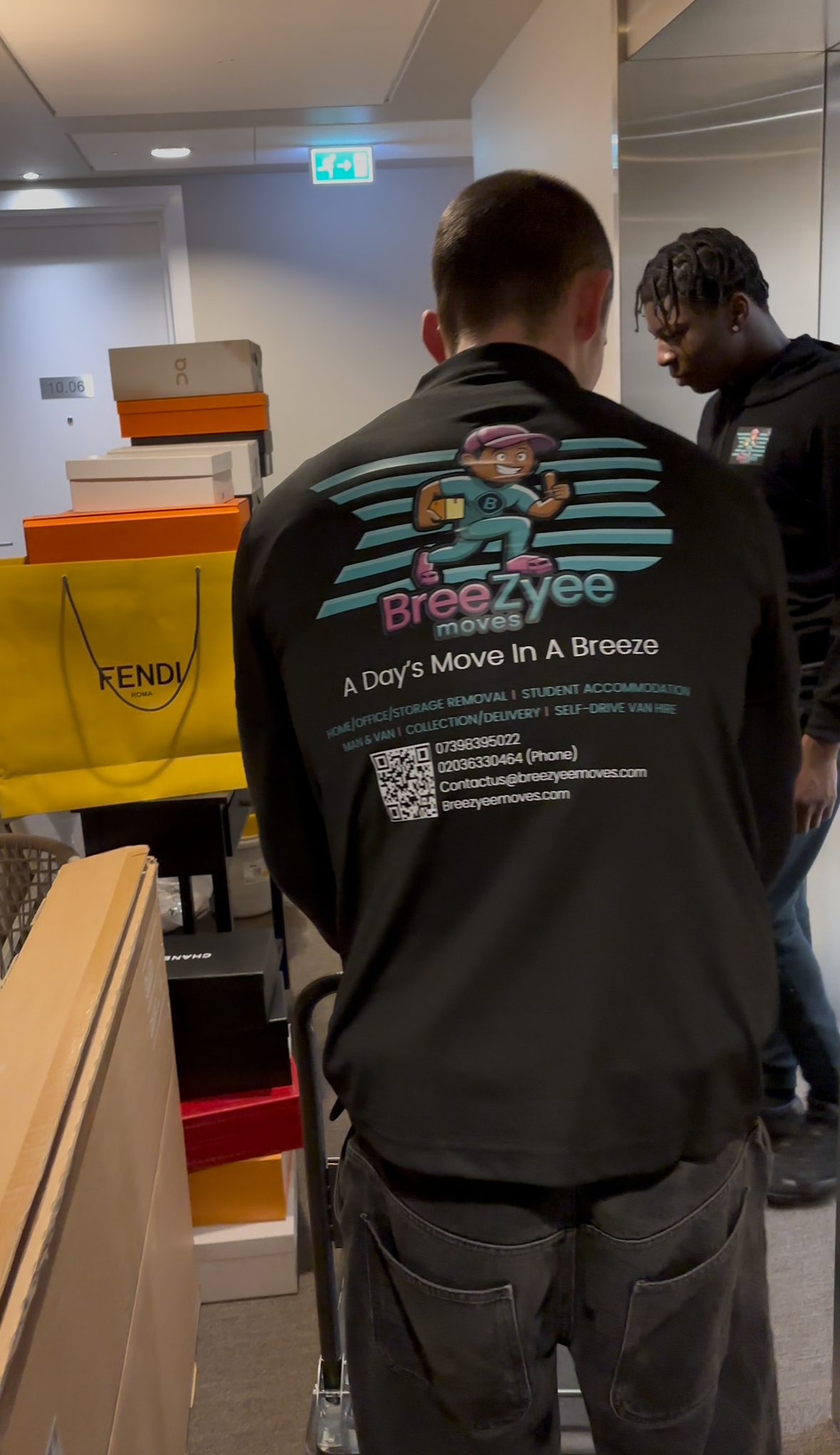 Two team members collaborating with full Breezyee branding visible