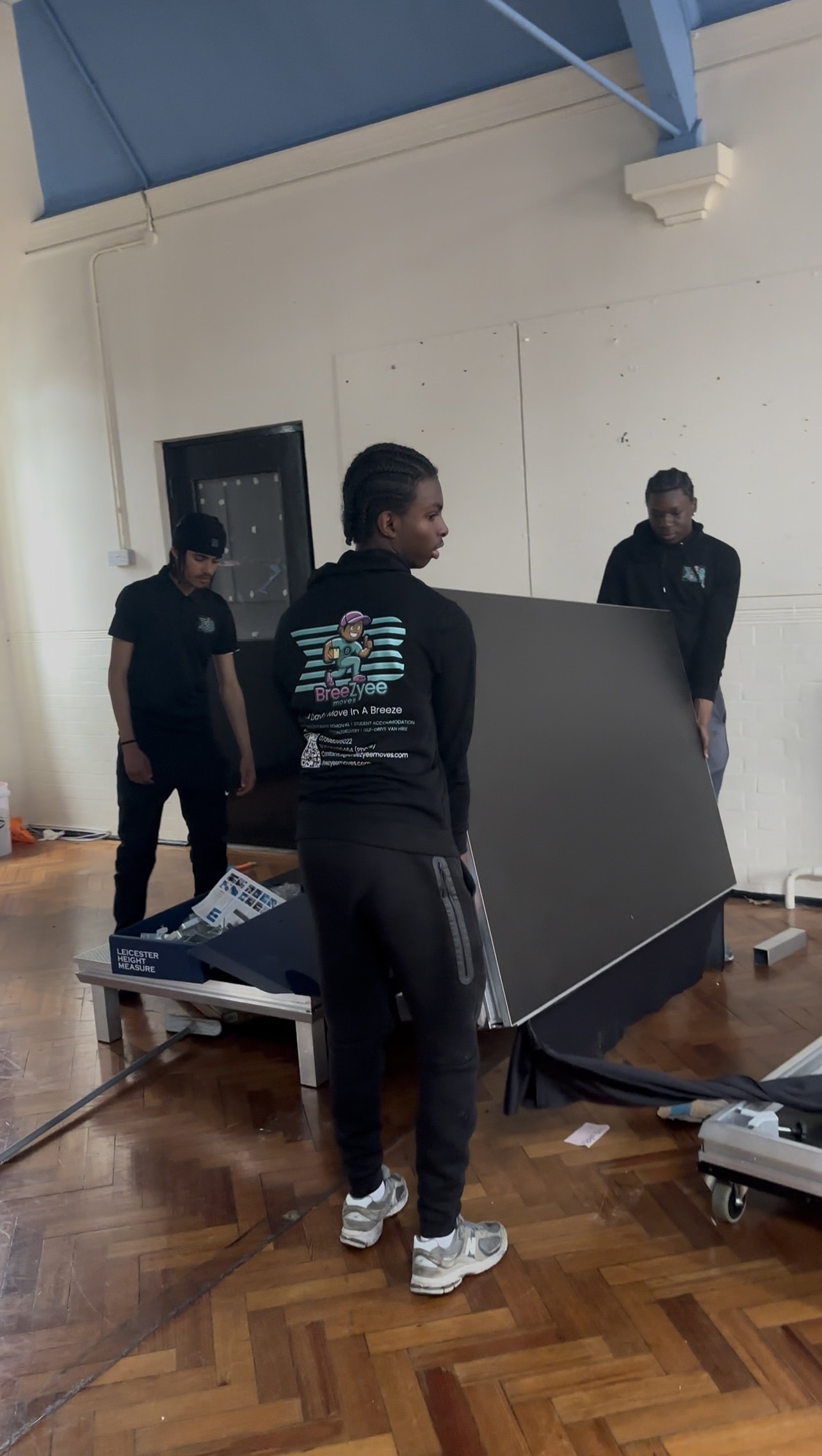 Breezyee team moving furniture together