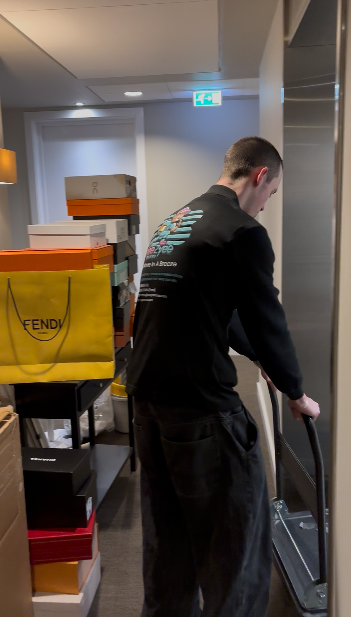 Team member using trolley in modern building corridor