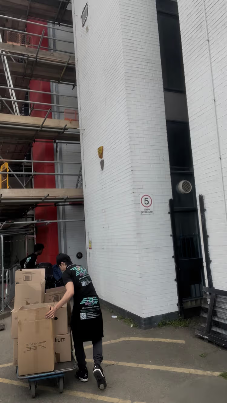 Team member with trolley handling boxes at commercial building