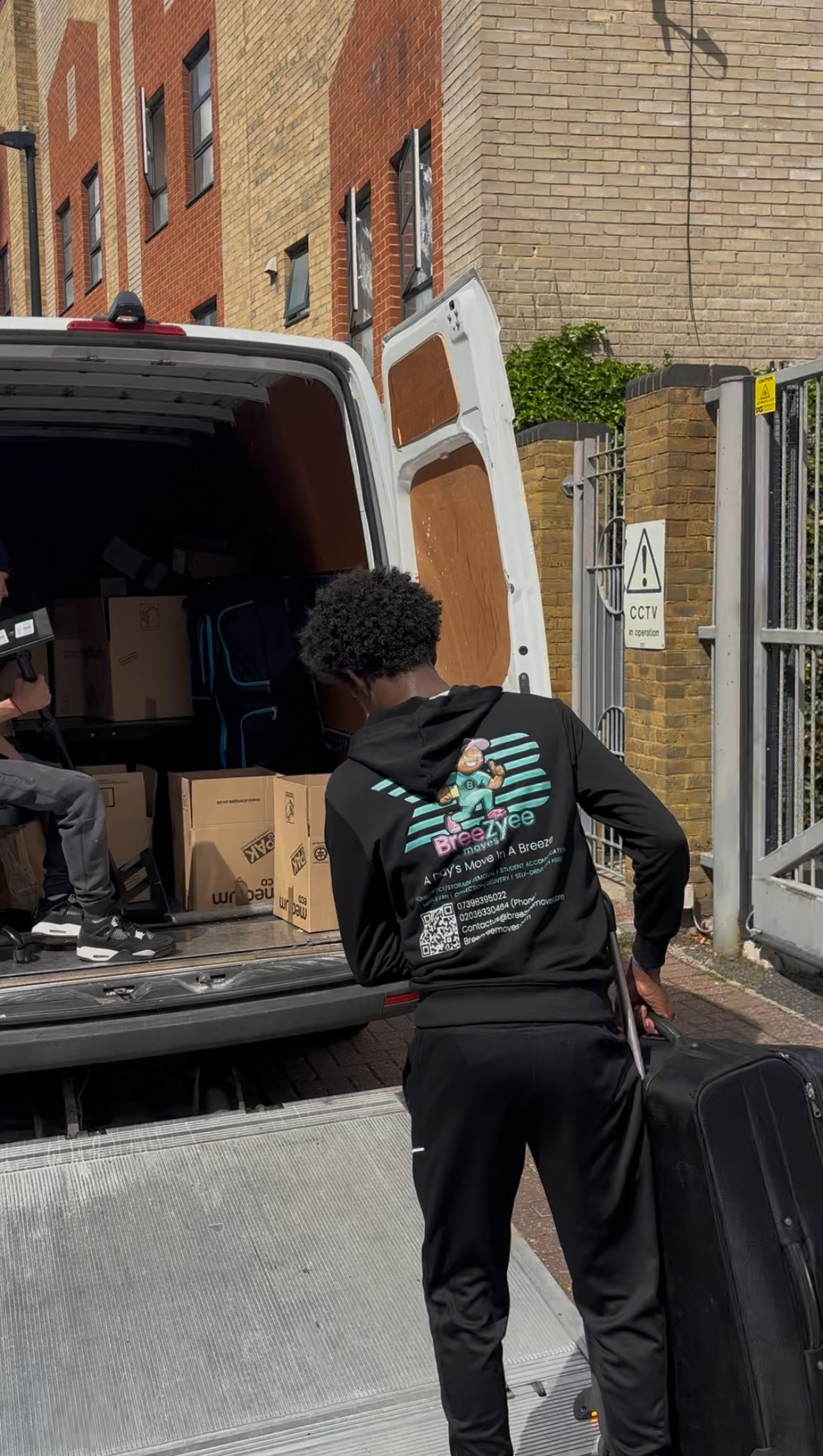 Team member loading van with professional equipment